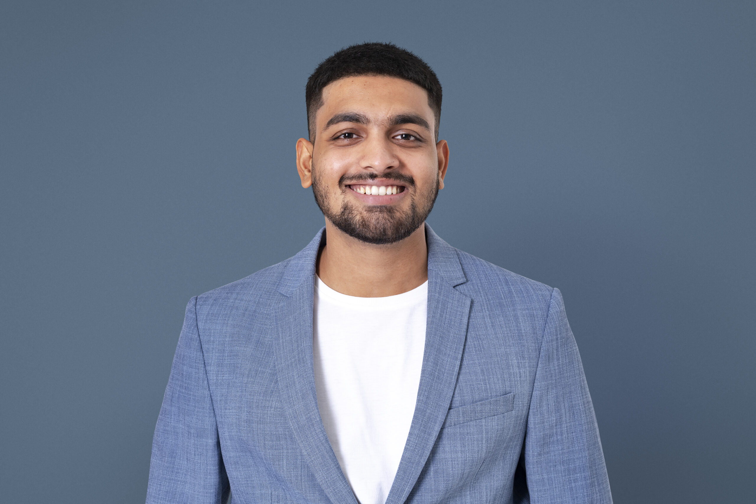 cheerful indian businessman smiling closeup portrait jobs career campaign scaled